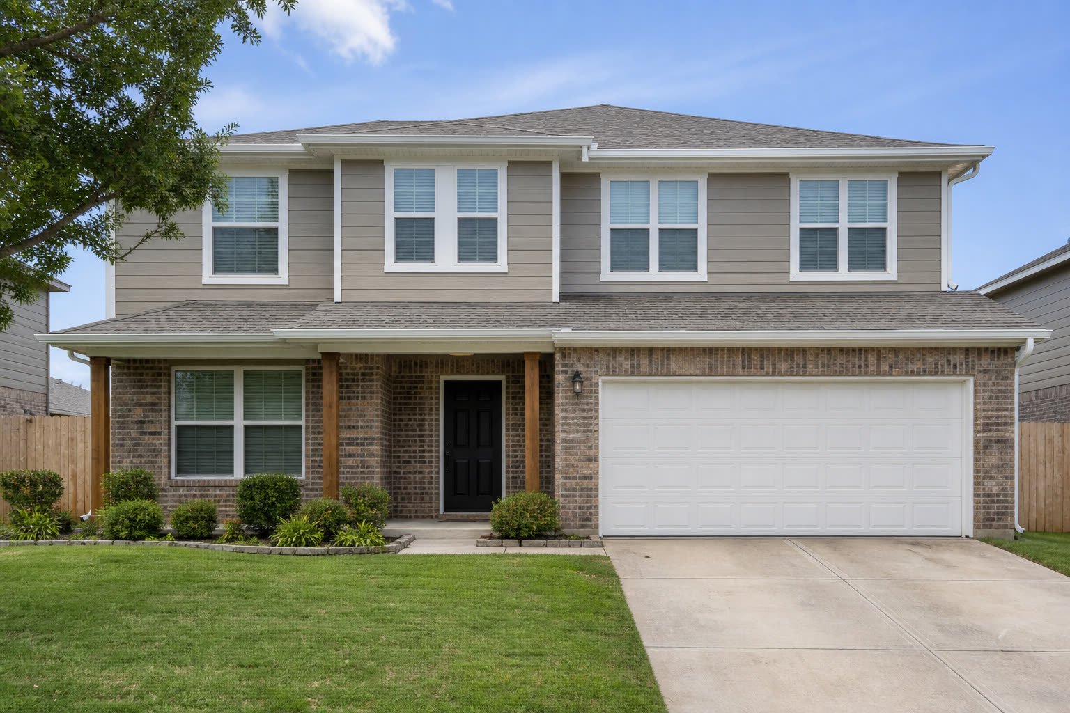 Two-story brick and siding after